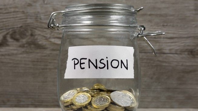 A jar of coins with a pension label on the front