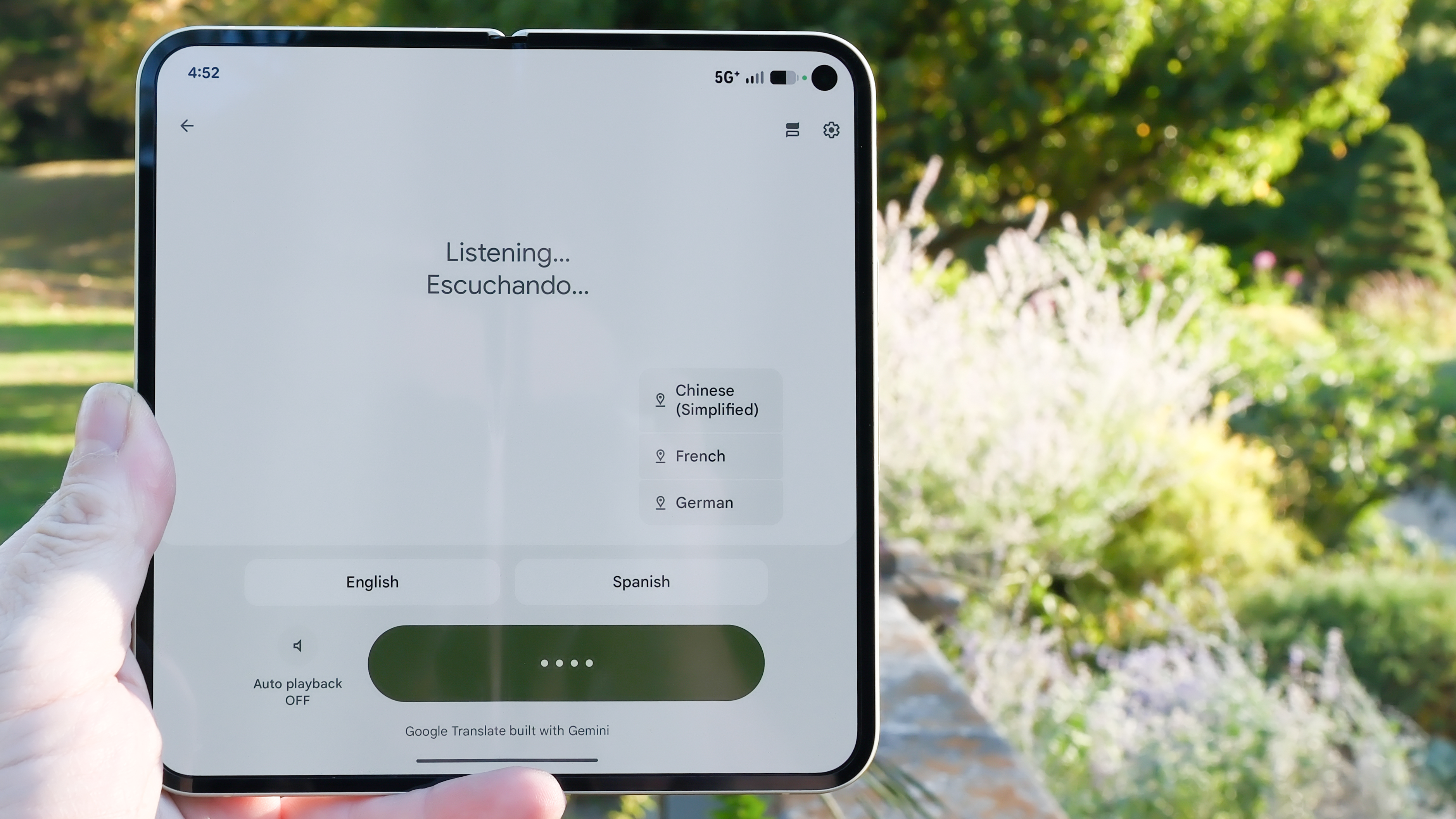 Google Pixel 10 Pro Fold in Jade green outside at a flower garden on a sunny day