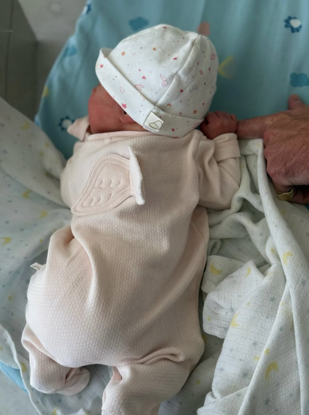 Princess Eugenie's baby daughter wearing a pink sleeper and hat
