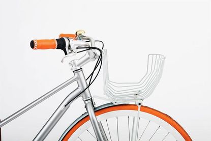 A aluminium bike with orange handles and wheel trim