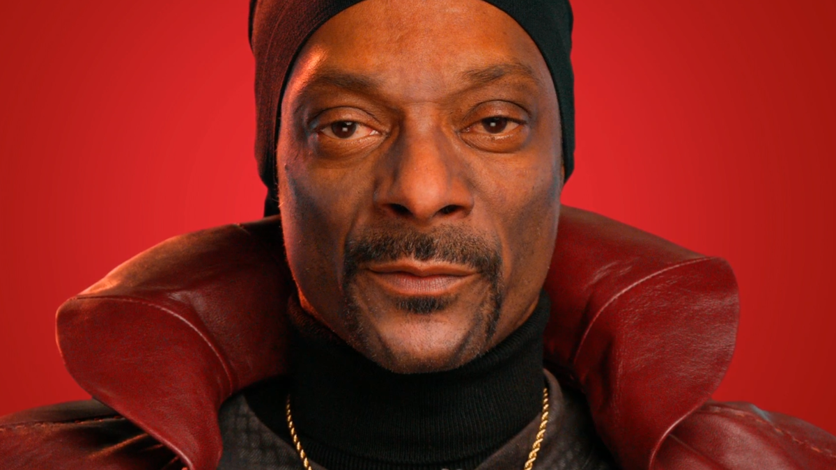 An image of Snoop Dogg as an AI chatbot named &quot;The Dungeon Master&quot;, wearing a fabulous red cape.