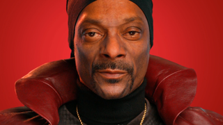 An image of Snoop Dogg as an AI chatbot named "The Dungeon Master", wearing a fabulous red cape.