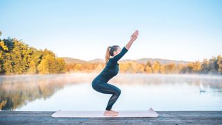 A woman holding the chair pose during yoga