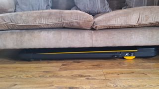 Urevo Strol 2E treadmill stored neatly underneath the sofa