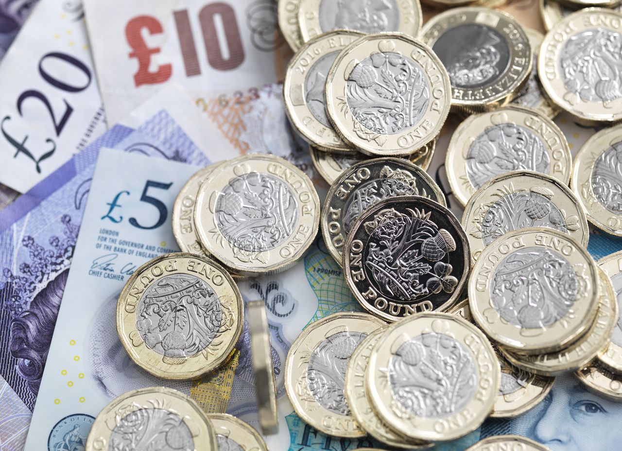 Pile of pound coins and pound notes