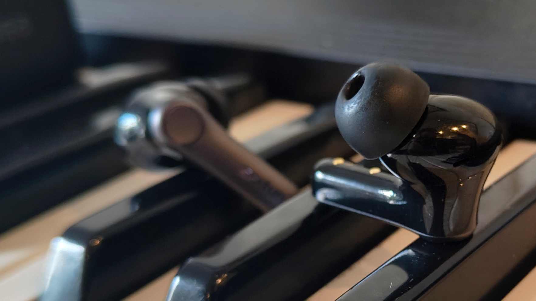 The Earfun Air Pro 4 Plus on top of a keyboard.