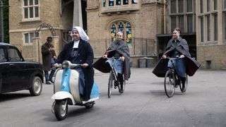 Sister Veronica (Rebecca Gethings) in a nun's habit riding a blue and white moped, while Trixie (Helen George) and Nancy (Megan Cusack) in nurses' uniforms follow behind on bikes in Call the Midwife