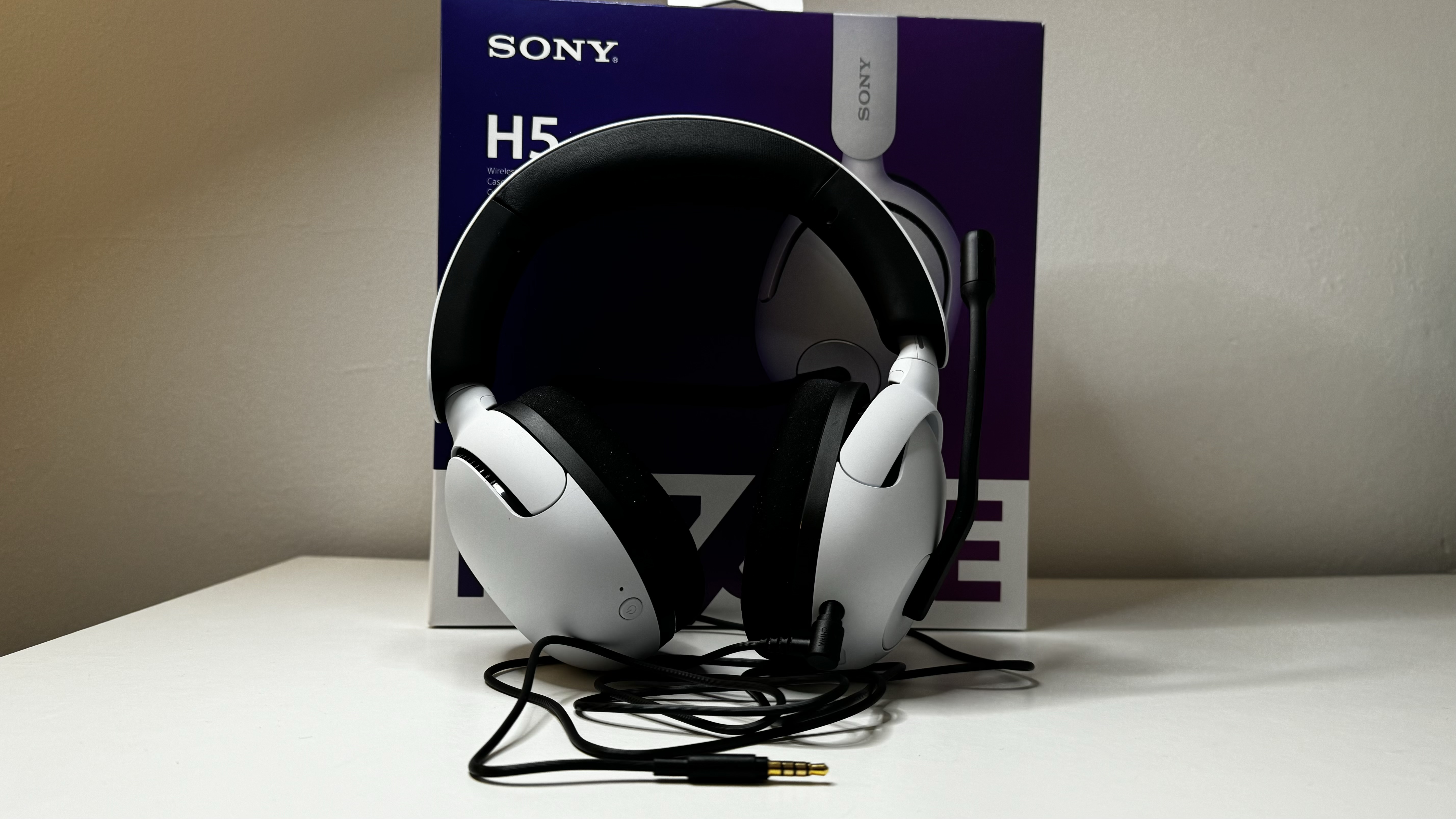 Sony InZone H5 gaming headset on a desk with packaging.