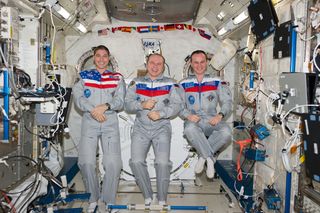 Expedition 38 crewmembers (from left) Mike Hopkins, Oleg Kotov and Sergey Ryazanskiy gather inside the International Space Station's Kibo laboratory for a crew portrait ahead of a planned March 10, 2014 landing aboard their Soyuz TMA-10 spacecraft