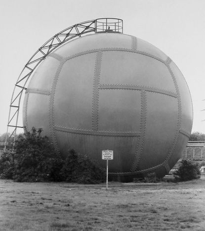 A pair of black and white photographs depicting an industrial structure and the inside of a chapel.