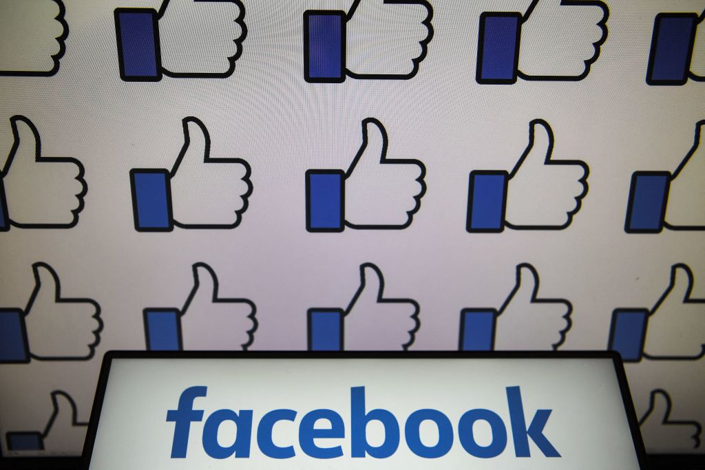 Facebook logo with Facebook thumbs repeating in the background