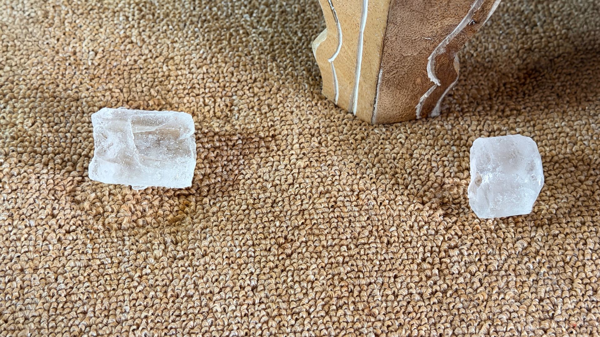 picture of ice cubes on carpet dents near furniture