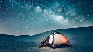 Tent under stars in night sky