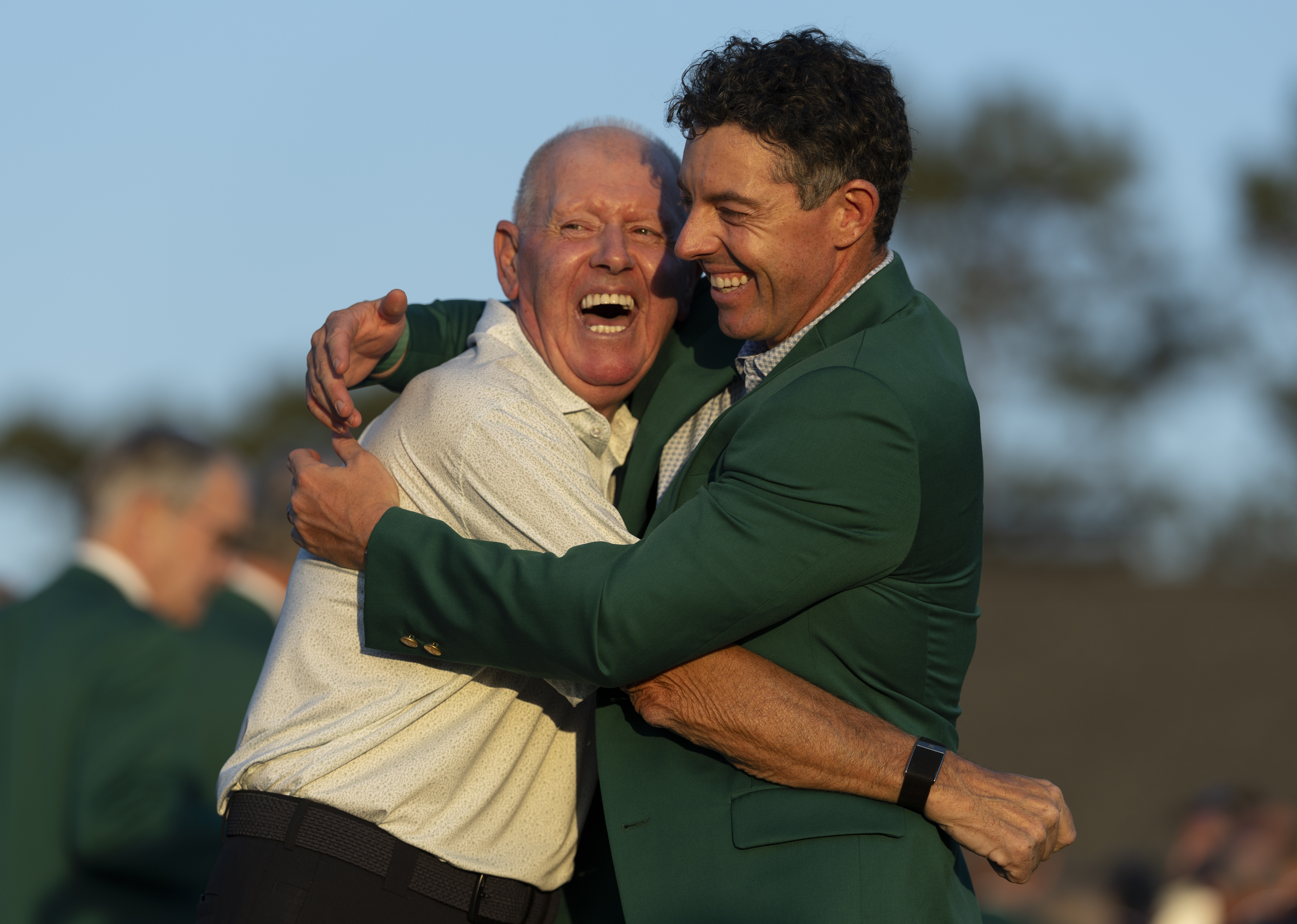 Masters champion Rory McIlroy and father Gerry McIIroy celebrate following the final round of the Masters at Augusta National Golf Club