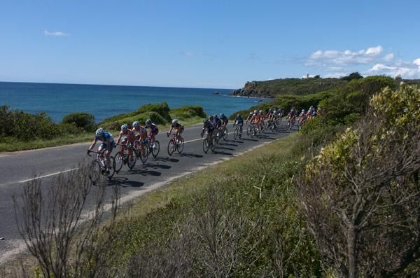 The peloton roll along beside Bass Strait in Devonport for the final stage of the tour.