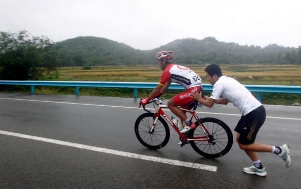 A rider gets a push back into the race.