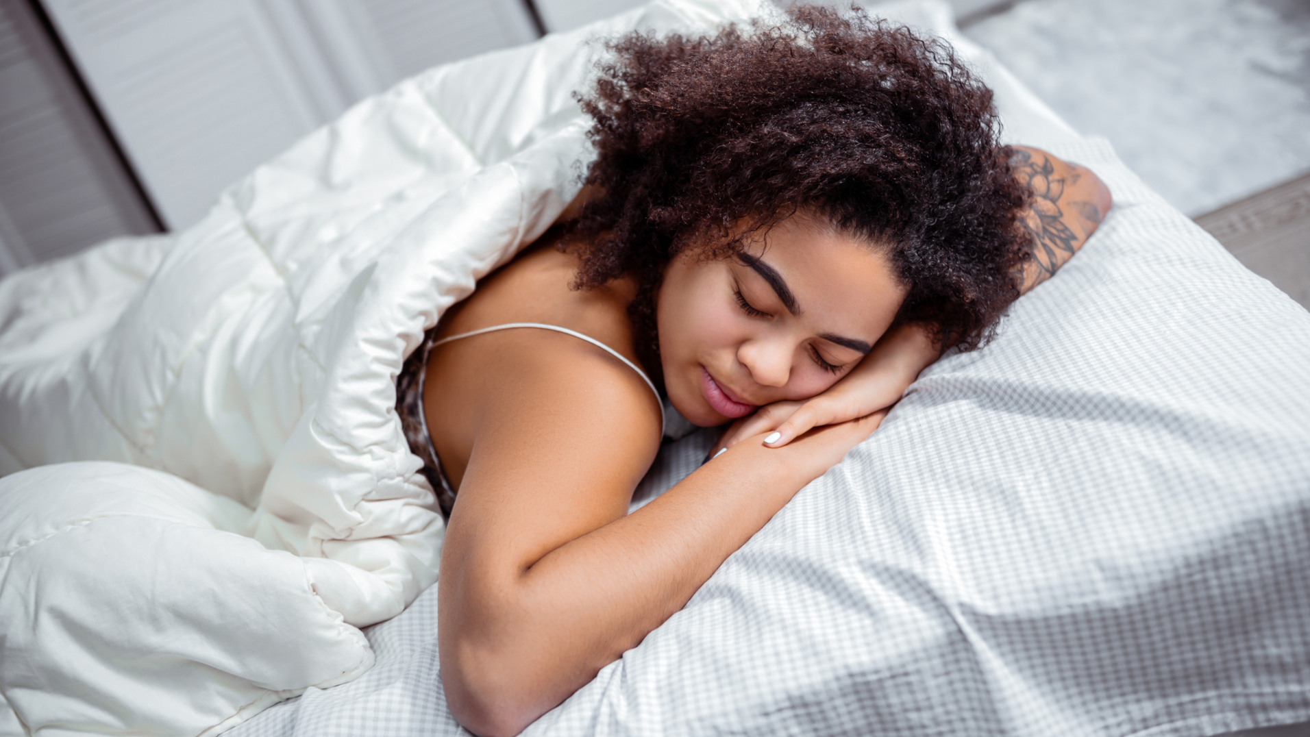 A woman sleeping on her front