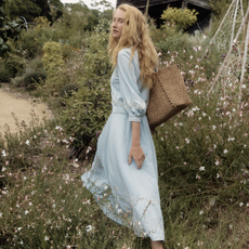 Woman in field wearing pale blue Fabrique dress
