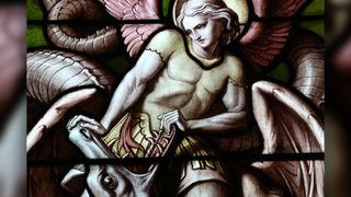 stained glass angel pushing dragon mouth open
