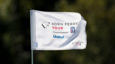 A pin flag with 'Korn Ferry Tour Championship' on flapping in the wind