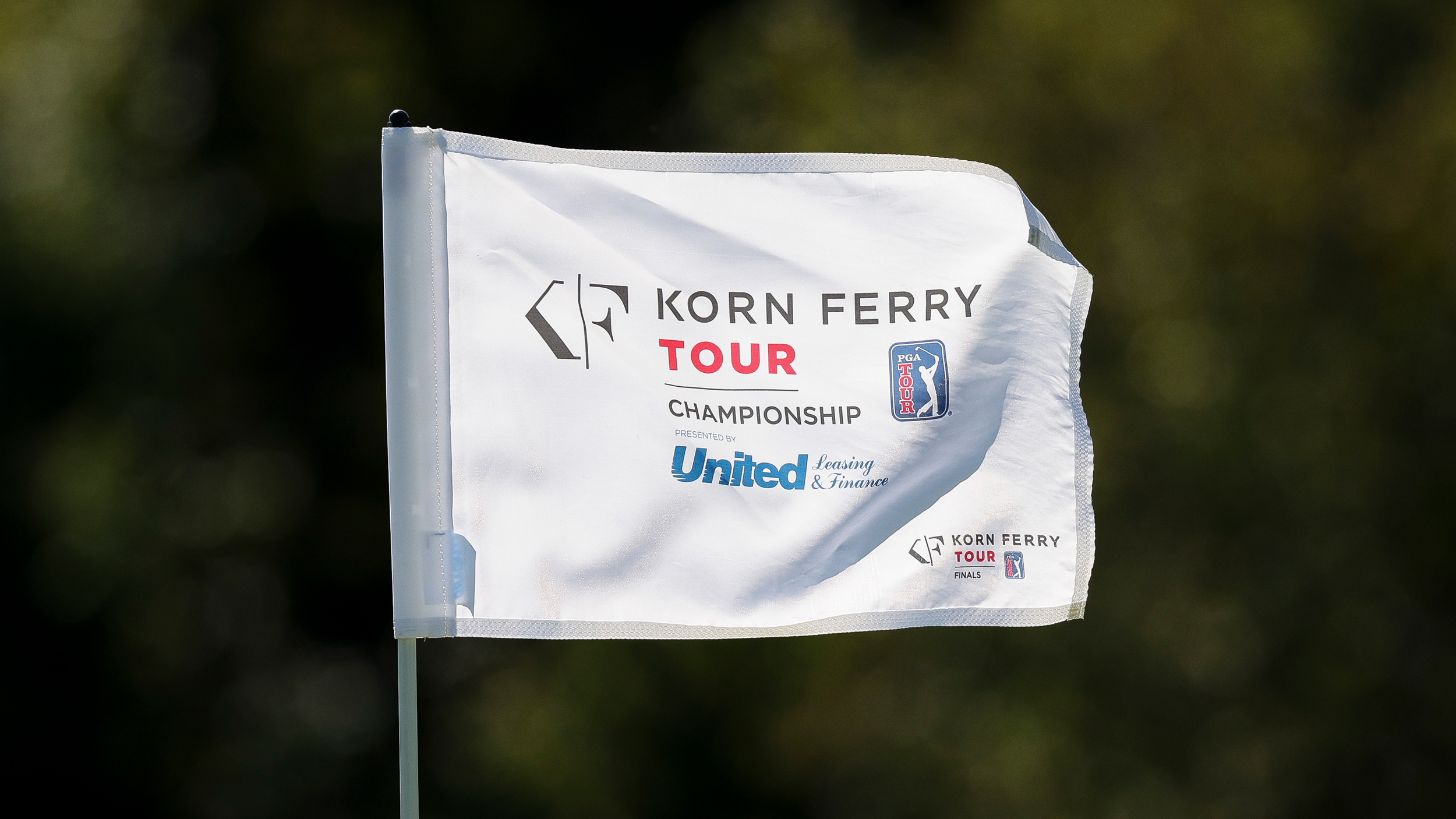 A pin flag with &#039;Korn Ferry Tour Championship&#039; on flapping in the wind