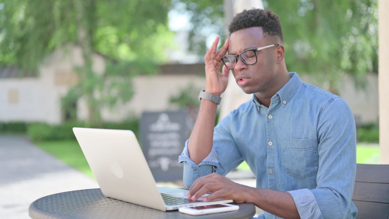 Stressed man at a laptop