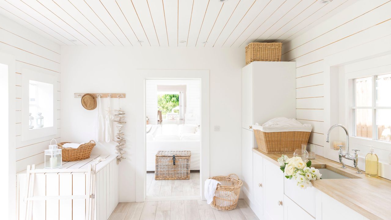 white shiplap walls in laundry room with sink