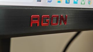 Close-up of the AGON logo on an AOC AGON AG275QXN monitor