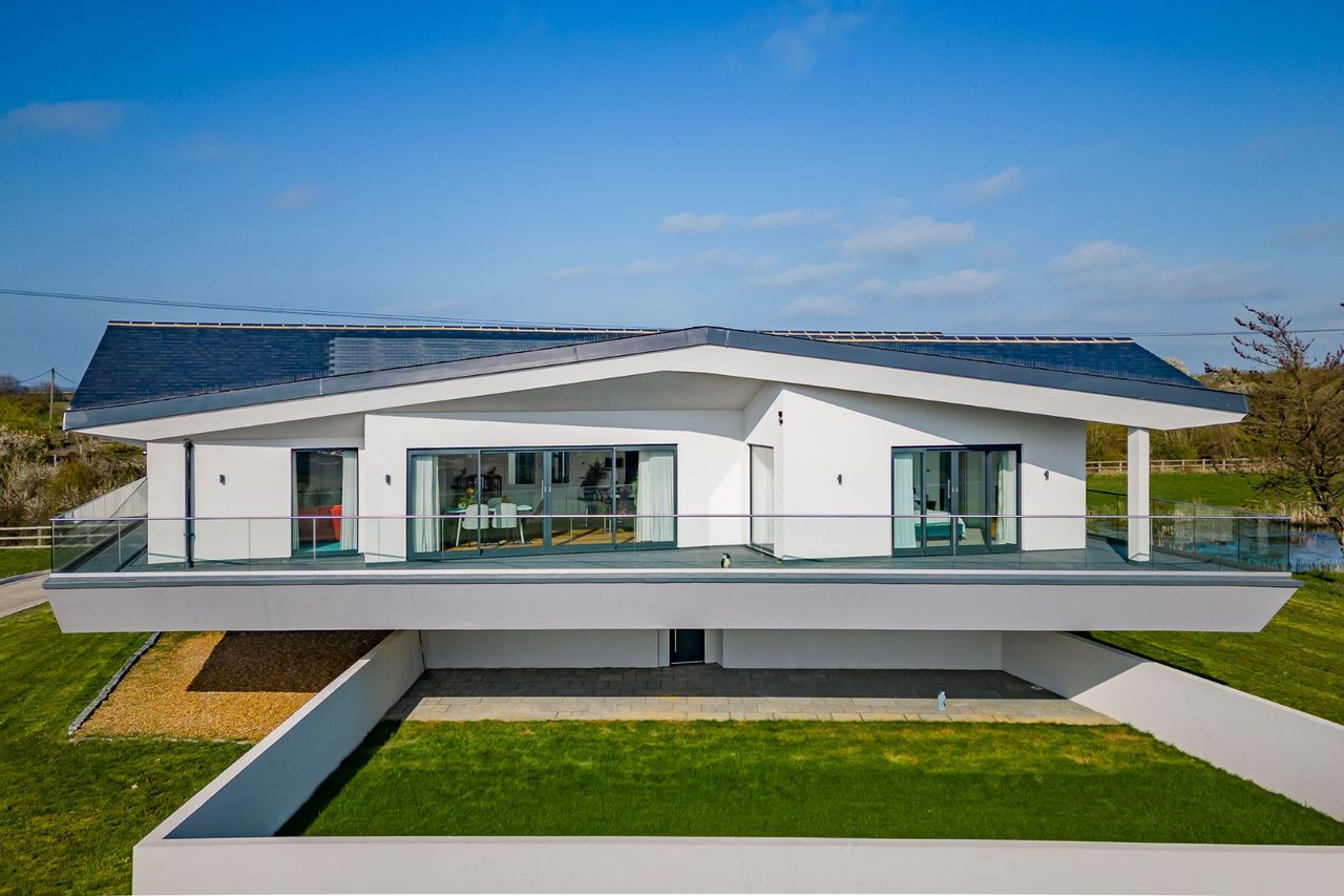 An overhead view of the front garden which looks over the balcony to see the home's bifold doors