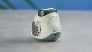 A pistachio green Fujifilm Instax Pal digital camera