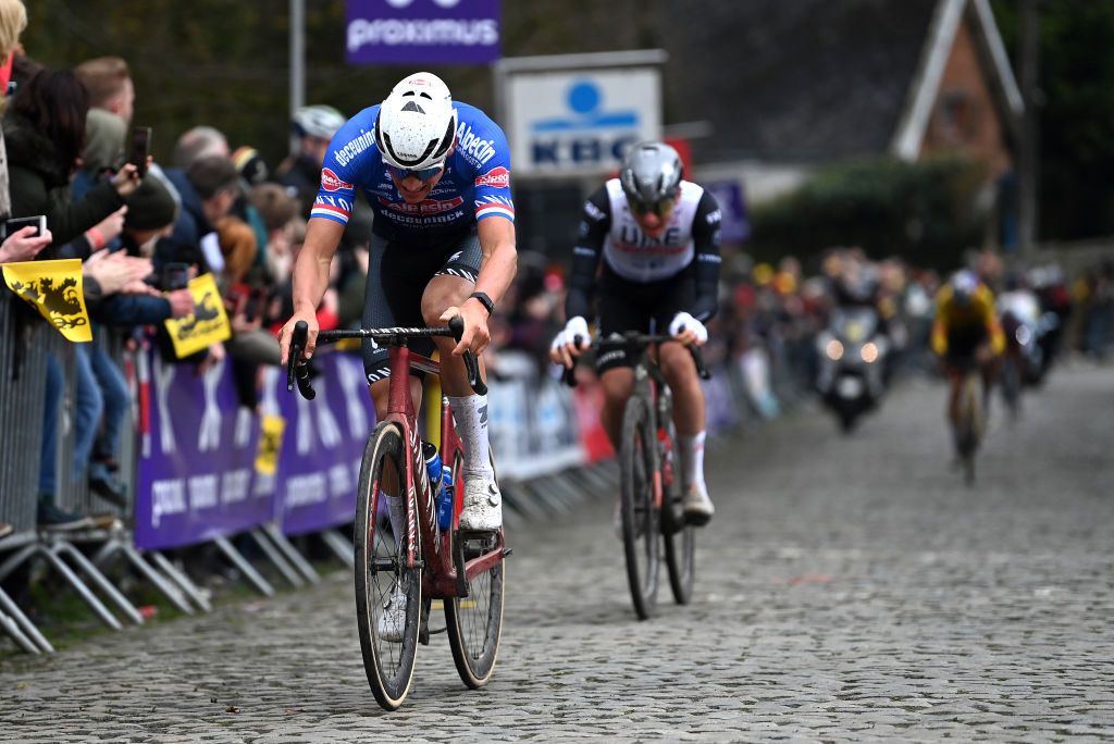 OUDENAARDE BELGIUM APRIL 02 LR Mathieu Van Der Poel of The Netherlands and Team AlpecinDeceuninck Tadej Pogacar of Slovenia and UAE Team Emirates and Wout Van Aert of Belgium and Team JumboVisma compete at Kwaremont cobblestones sector during the 107th Ronde van Vlaanderen Tour des Flandres 2023 Mens Elite a 2734km one day race from Brugge to Oudenaarde UCIWT on April 02 2023 in Brugge Belgium Photo by Tim de WaeleGetty Images