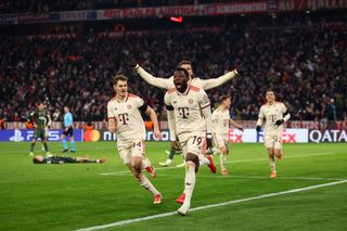 Alphonso Davies of Bayern Munich celebrates scoring his team's first goal during the UEFA Champions League 2024/25 League Knockout Play-off second leg match between FC Bayern München and Celtic FC at Allianz Arena on February 18, 2025 in Munich, Germany.