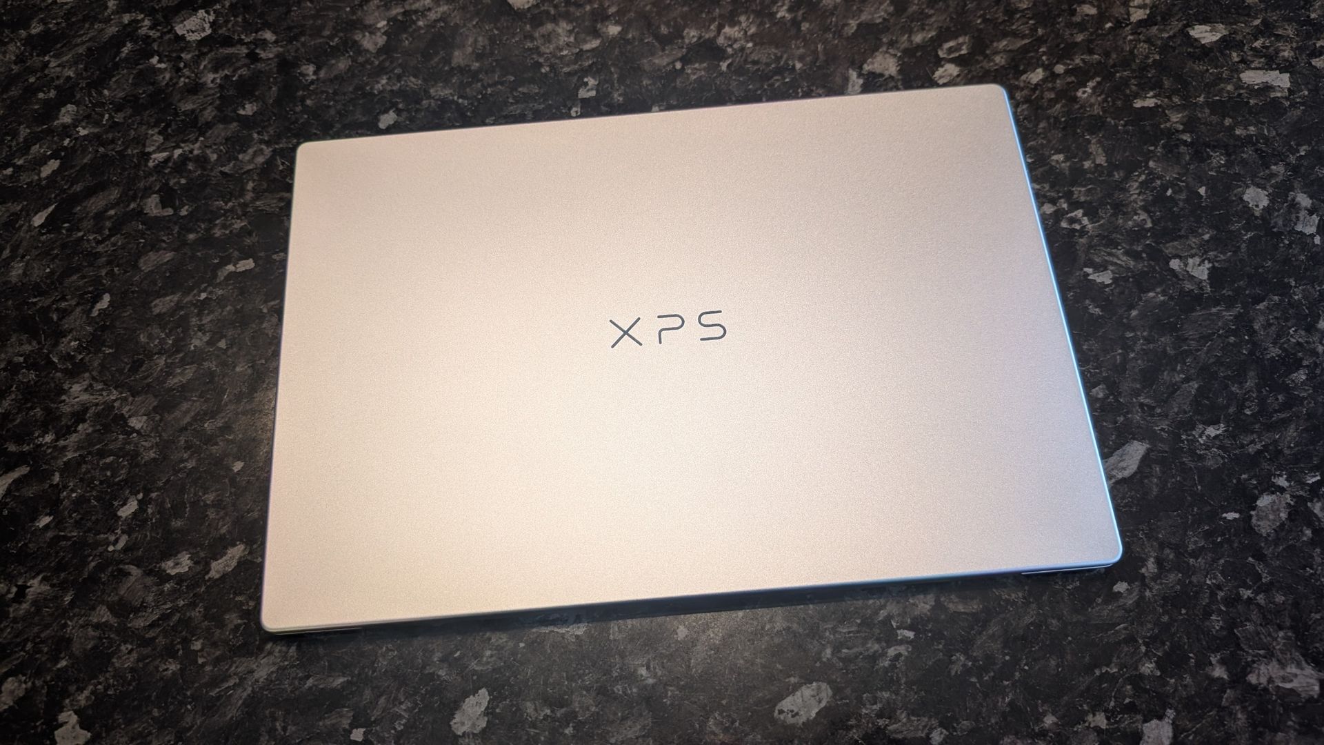 The Dell XPS 13 (2026) laptop pictured on a black marble worktop.
