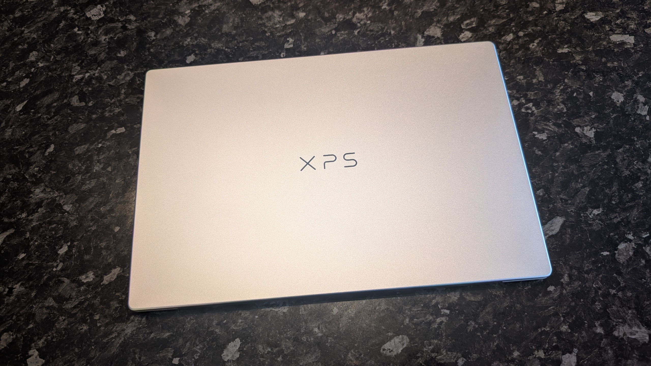 The Dell XPS 13 (2026) laptop pictured on a black marble worktop.
