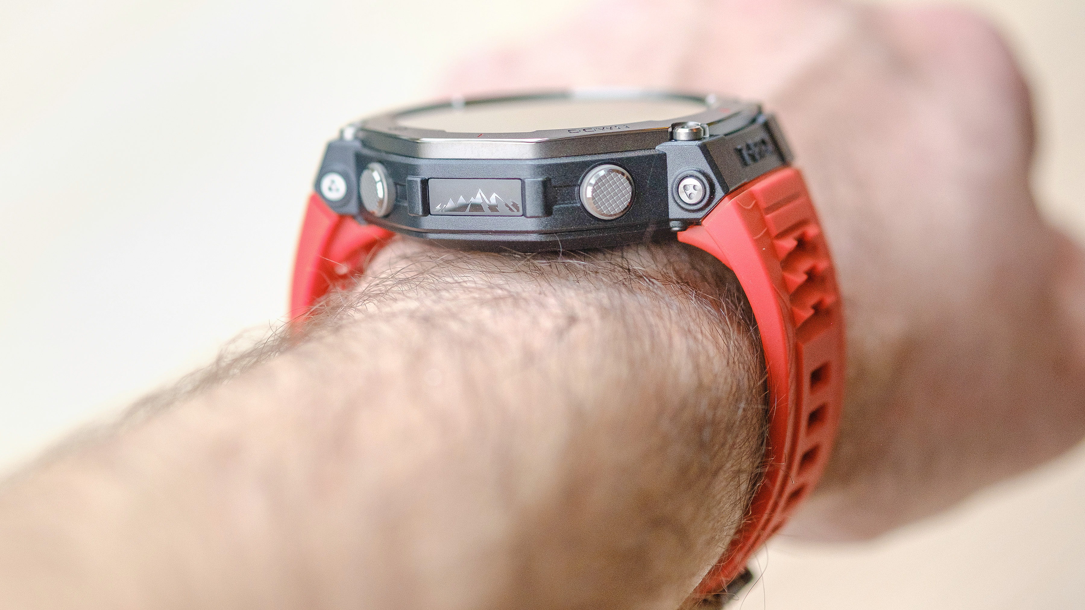 Close up of the Amazfit T-Rex 3 smartwatch on an orange silicone strap