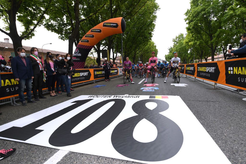 NOVARA ITALY MAY 09 Edoardo Affini of Italy and Team Jumbo Visma Purple Points Jersey Filippo Ganna of Italy and Team INEOS Grenadiers Pink Leader Jersey Tobias Foss of Norway and Team Jumbo Visma White Best Young Rider Jersey paying tribute to Wouter Weylandt of Belgium who died in a crash during the third stage of the 2011 Giro dItalia during the 104th Giro dItalia 2021 Stage 2 a 179km stage from Stupinigi Nichelino to Novara girodiitalia Giro UCIworldtour on May 09 2021 in Novara Italy Photo by Tim de WaeleGetty Images