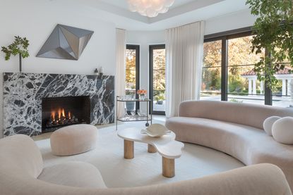 A living room with marble fireplace