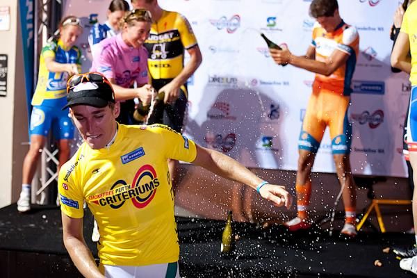Giacoppo runs from the spray of champagne.