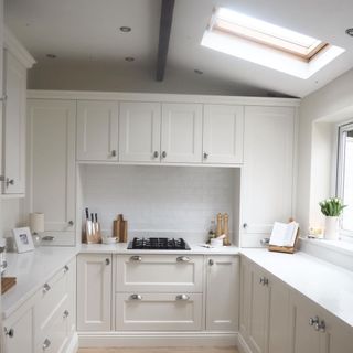 All white kitchen with small skylight window