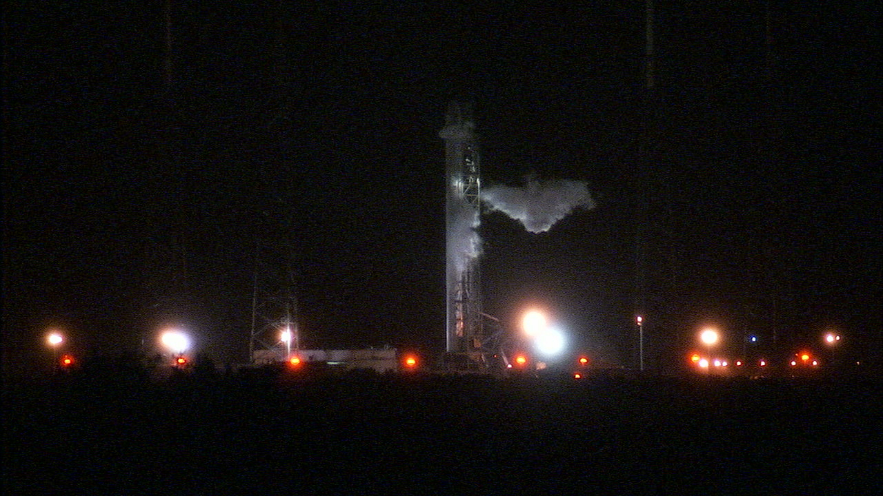 A SpaceX Falcon 9 rocket carrying an unmanned Dragon cargo ship stands atop a launch pad at Florida&#039;s Cape Canaveral Air Force Station early on Saturday, Sept. 20, 2014 in this NASA image.