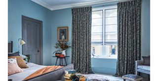blue cosy bedroom with layered window treatments to make a bedroom cosy