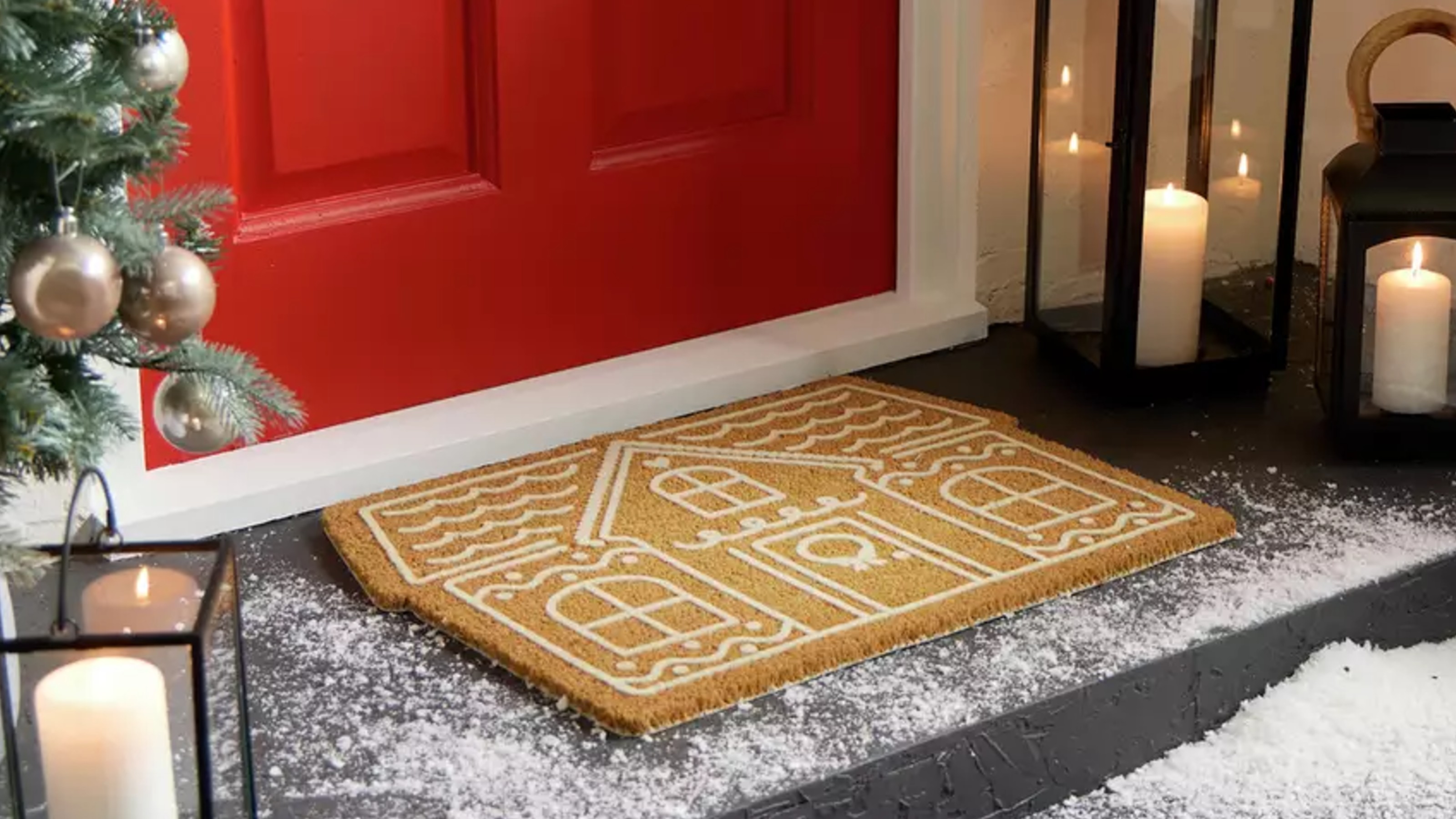 Habitat Gingerbread House Christmas Doormat outside a red front door