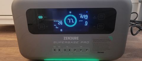 The Zendure SuperBase Pro 1500w on a wooden floor displaying the charge percentage and other details on an LCD screen