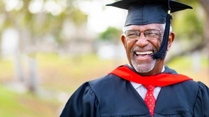 A senior man graduates with his master's degree