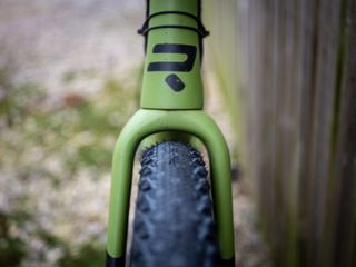 Detail photo of a green Ridley ASTR RS leaning against a wooden fence