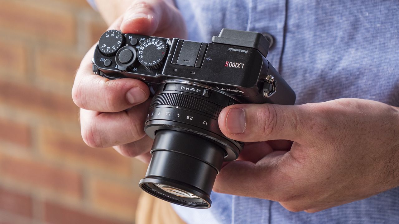 Panasonic Lumix LX100 II compact camera in the hand
