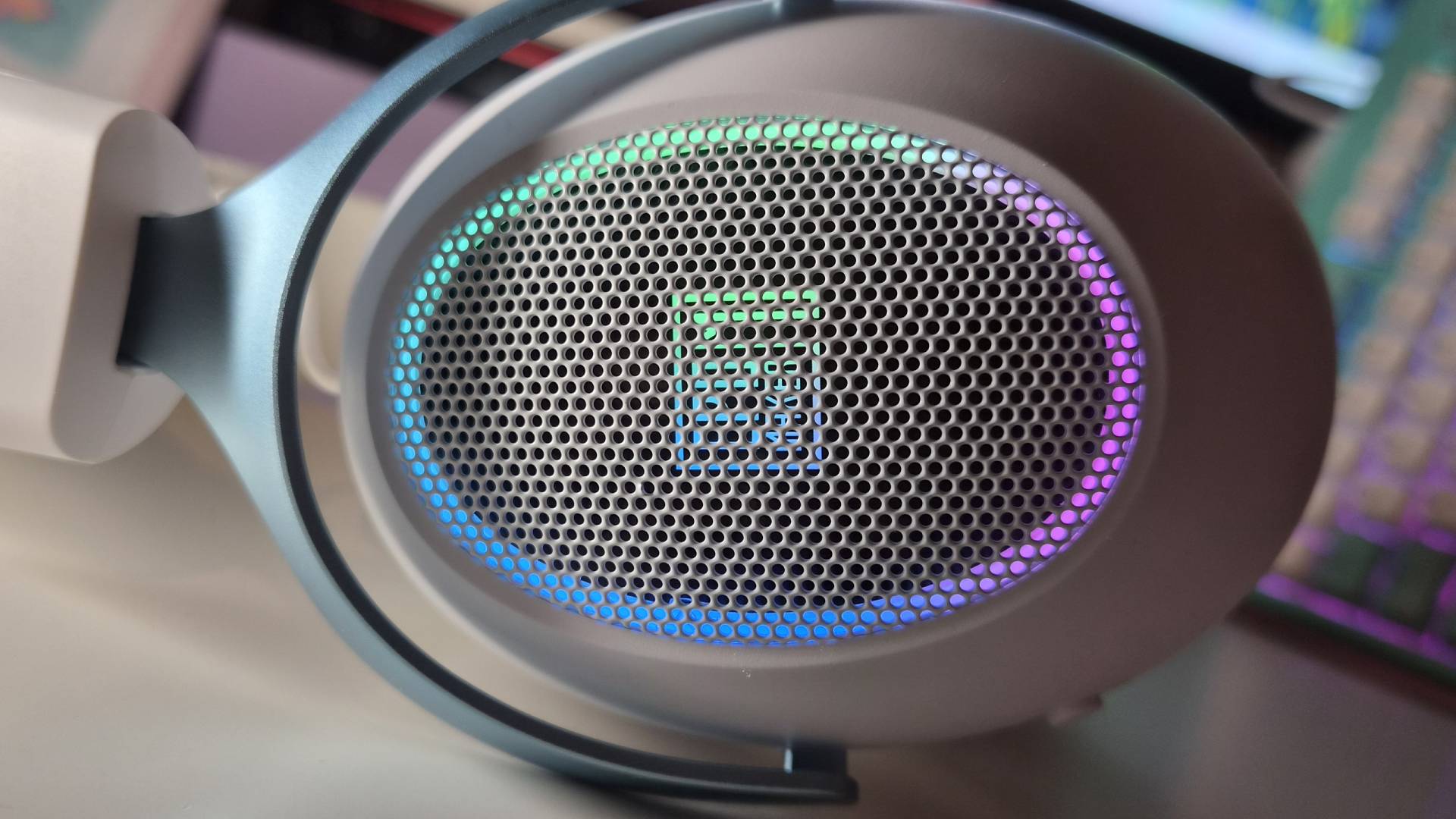 Photo of the Epomaker GX1 headset sitting on a white desk.