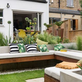 garden area with banquette seating and white bench
