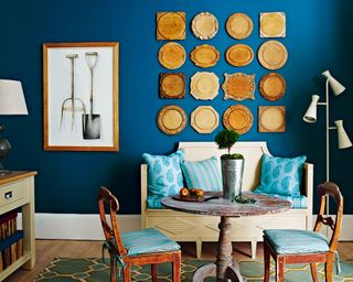 Gallery wall ideas with chopping boards on blue wall