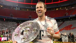 Harry Kane of Bayern Munich poses for a photo with the Meisterschale trophy and his medal after the teams 2-0 victory in the Bundesliga match between FC Bayern München and Borussia Mönchengladbach at Allianz Arena on May 10, 2025 in Munich, Germany.